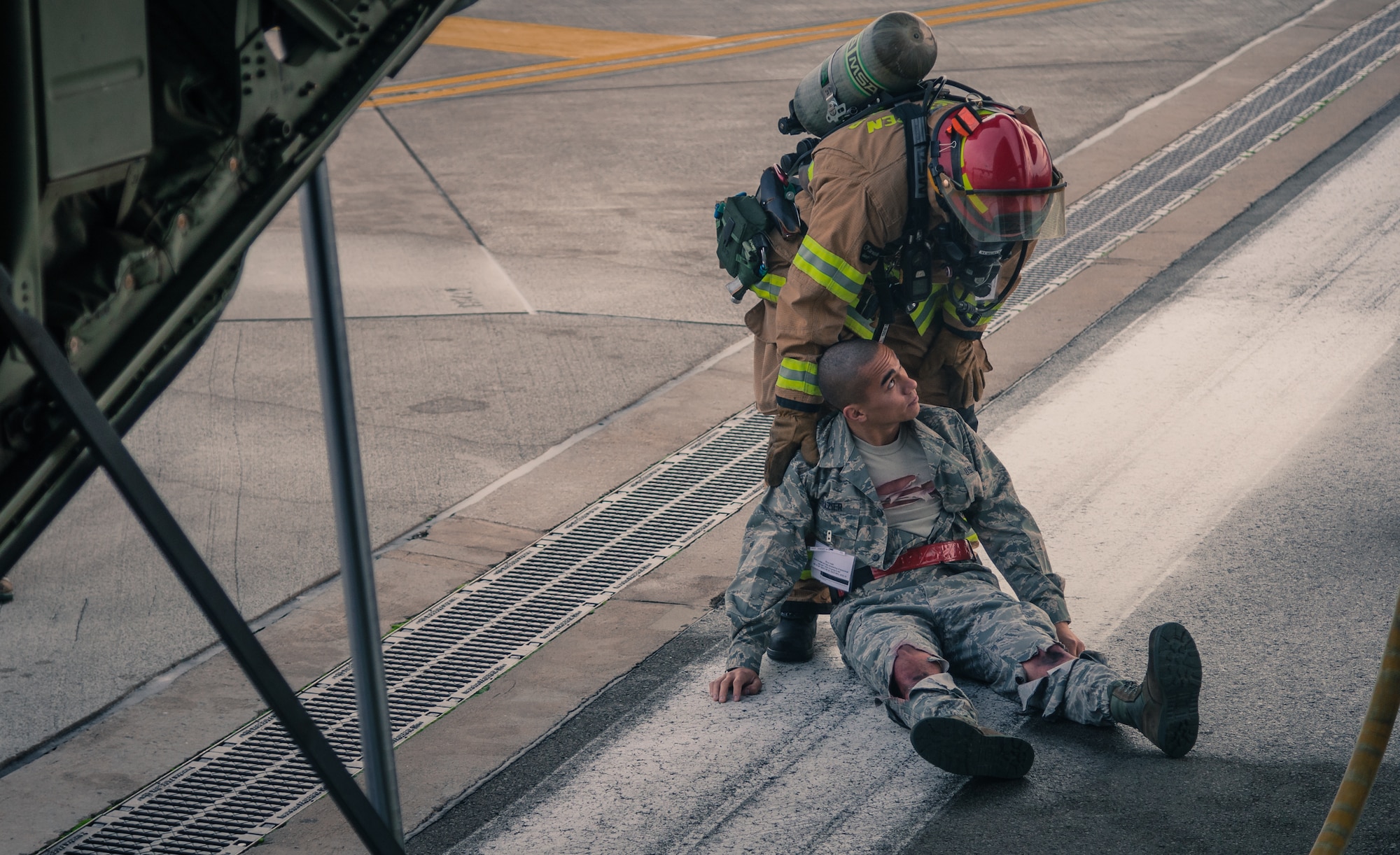 A firefighter removes an injured passenger from the wreck of a simulated aircraft crash as part of a major accident response exercise on Ramstein Air Base, Germany, Oct. 18, 2014. Members of the Air Force and host nation agencies partnered in conducting a response and recovery in preparation for possible real-world incidents. (U.S. Air Force photo/Airman 1st Class Jordan Castelan)