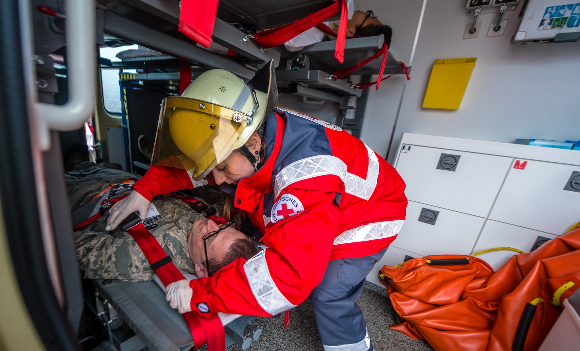 An Airman receives medical attention from a host nation emergent medical technician as part of a major accident response exercise on Ramstein Air Base, Germany, Oct. 18, 2014. Members of the Air Force and host nation agencies partnered in conducting a response and recovery in preparation for possible real-world incidents. (U.S. Air Force photo/Airman 1st Class Jordan Castelan)