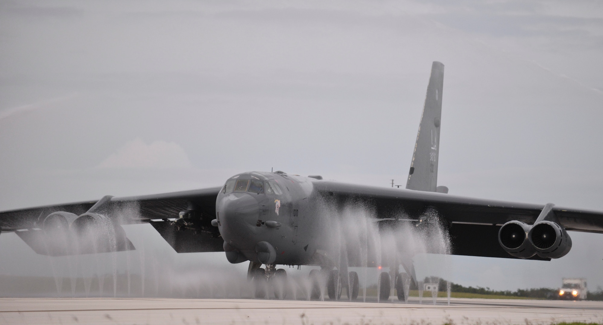 A B-52 Stratofortress taxis through the wash rack, also known as a bird bath, after a mission Oct. 8, 2014. The aircraft was piloted by Lt. Col. Steve Smith, 93rd Bomb Squadron from Barksdale Air Force Base, La., who reached the 9,000 flying-hour mark, leaving him with the most flying hours in a B-52H; the next aviator is 2,000 hours behind him. (U.S. Air Force photo by Staff Sgt. Robert Hicks/Released)