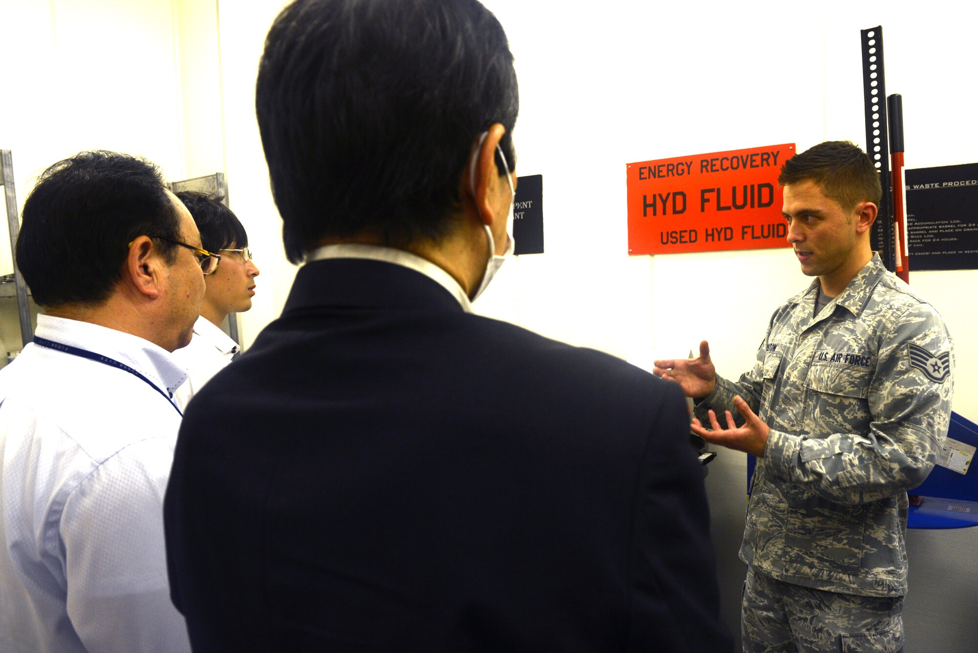 Staff Sgt. Jeffrey Marston, 730th Air Mobility Squadron, describes safety measures used for fuel storage at Yokota Air Base, Japan, Oct. 10, 2014. Marston and other members of the 730 AMS adhere to guidelines put in place by the Air Force and Japan when storing and handling hazardous materials. (U.S. Air Force photo by Airman 1st Class David C. Danford/Released)