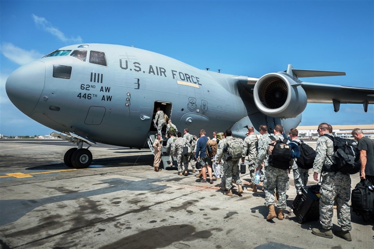 A group of 30 U.S. military personnel, including Marines, airmen, and soldiers from the 101st Airborne Division, board an Air Force C-17 Globemaster III at Leopold Sedar Senghor International Airport in Dakar, Senegal, Oct. 19, 2014. The service members are bound for Monrovia, Liberia, where U.S. troops will construct medical treatment units and train health care workers as part of Operation United Assistance, the U.S. Agency for International Development-led, whole-of-government effort to respond to the Ebola outbreak in West Africa. U.S. Air Force photo by Maj. Dale Greer
