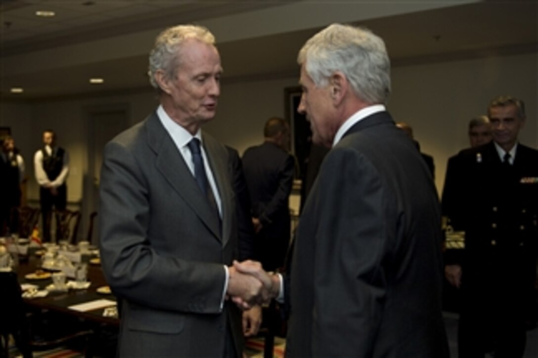 Defense Secretary Chuck Hagel, right, greets Spain's Minister of Defense Pedro Morenes as he arrives at the Pentagon to discuss matters of mutual importance, Oct. 17, 2014. 