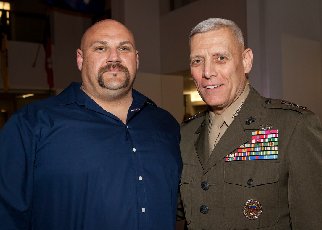 The Assistant Commandant of the Marine Corps, Gen. John M. Paxton, Jr., right, poses for a photo with a guest at the Embassy of Australia in Washington, D.C., Oct. 17, 2014. The Ambassador of Australia, Kim Beazley, hosted a dinner event in honor of U.S. wounded service members. (U.S. Marine Corps photo by Cpl. Tia Dufour/Released) 