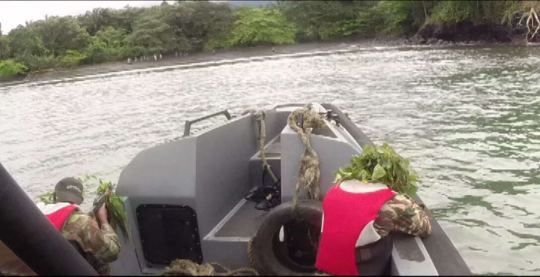 Members of the Cameroonian Naval Commando Company (COPALCO) stand security duty while conducting a final exercise in Cameroon, Sept. 28, 2014. Maneuvering in the river, while simultaneously fighting against currents and other natural obstacles is a key component in maritime interdiction. While on a theater security cooperation engagement, Security Cooperation Team 5B with Special Purpose Marine Air Ground Task Force-Crisis Response-Africa, worked with the COPALCO on marksmanship, boat operations, and patrolling. (Courtesy Photo)