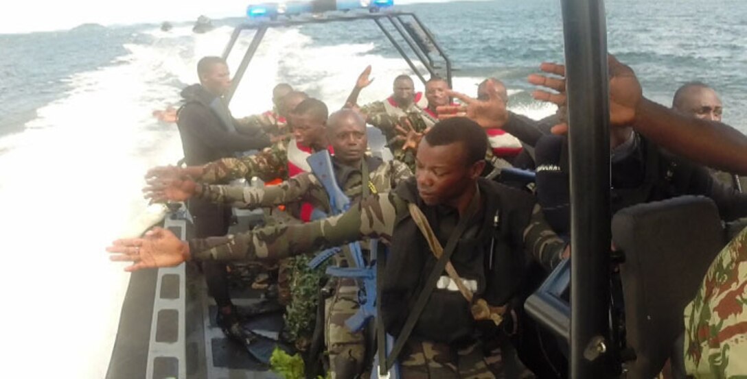 Members of the Cameroonian Naval Commando Company (COPALCO) give a hand signal while practicing patrolling techniques in Cameroon, Sept. 28, 2014. Maneuvering in the river, while simultaneously fighting against currents and other natural obstacles is a key component in maritime interdiction. While on a theater security cooperation engagement, Security Cooperation Team 5B with Special Purpose Marine Air Ground Task Force-Crisis Response-Africa, worked with the COPALCO on marksmanship, boat operations, and patrolling. (Courtesy Photo)