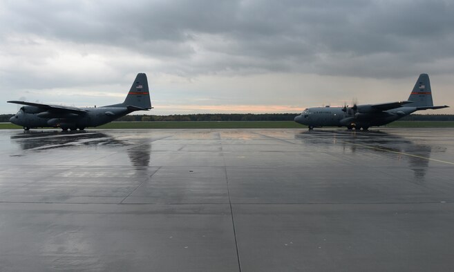 Two C-130 Hercules wait to taxi on the flightline Oct. 20, 2014, during U.S. Air Force Aviation Detachment rotation 15-1, at Powidz Air Base, Poland. The C-130s are assigned to Illinois Air National Guard’s 182nd Airlift Wing. The 182nd AW brought three aircraft to participate in the rotation hosted by the U.S. Aviation Detachment, 52nd Operations Group, at Łask Air Base, Poland. (U.S. Air Force photo/Airman 1st Class Dylan Nuckolls)