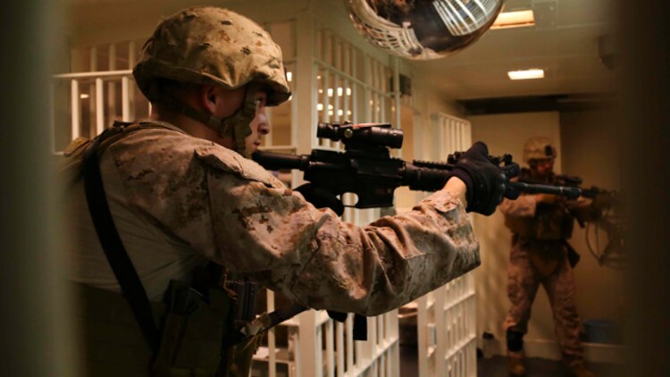 Cpl. Andrew J. Citriniti, a military policeman with the 11th Marine Expeditionary Unit (MEU), and Sauquoit, New York native, practices close quarter tactics aboard the USS Makin Island (LHD 8), Oct. 11.  The Makin Island Amphibious Ready Group (ARG) and the embarked 11th MEU are deployed in support of maritime security operations and theater security cooperation efforts in the U.S. 5th Fleet area of responsibility. (U.S. Marine Corps photo by Cpl. Laura Y. Raga/ RELEASED)