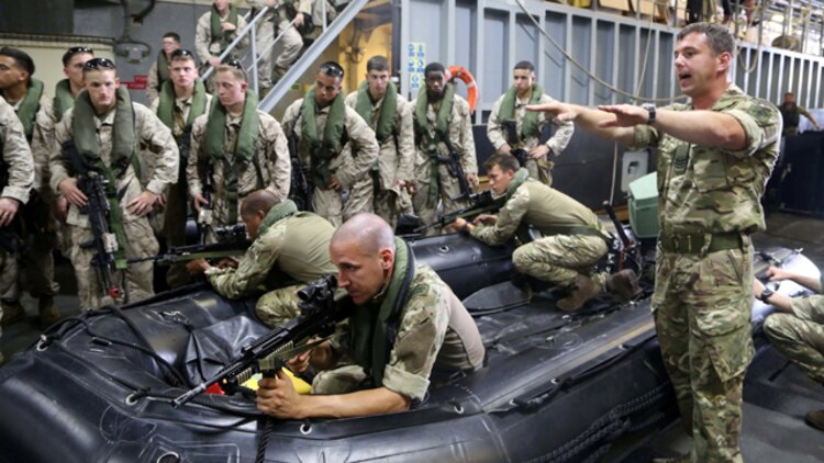 A Royal Marine officer with Task Force Cougar gives a period of instruction to Marines with Fox Company, Battalion Landing Team 2nd Battalion, 1st Marines, 11th Marine Expeditionary Unit (MEU), aboard the U.K. Royal Navy’s RFA Lyme Bay (L3007) during Exercise Cougar Voyage 15. Cougar Voyage in an exercise aimed to strengthen proficiencies, promote interoperability and increase military-to-military relationships to support long-term regional security in the U.S. 5th Fleet area of responsibility. (U.S. Marine Corps photos by Cpl. Demetrius Morgan/Released)