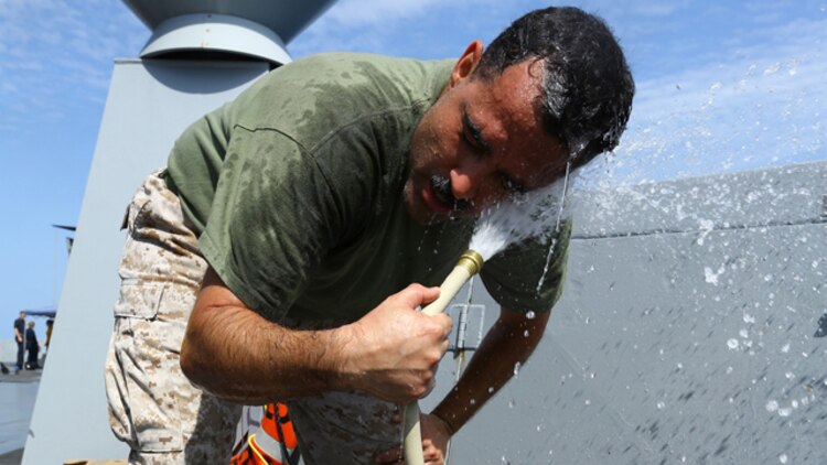 U.S. Navy Hospital Corpsman Chief Petty Officer Juan J. Rivera with Combat Logistics Battalion 11, 11th Marine Expeditionary Unit (MEU) and native of Brooklyn, New York, rinses Oleoresin Capsicum (OC) spray, also known as pepper spray, from his face during an OC spray and nonlethal weapons qualification course aboard the USS San Diego (LPD 22), Oct. 10. The 11th MEU is embarked with the Makin Island Amphibious Ready Group and deployed to maintain regional security in the U.S. 5th Fleet area of responsibility. (U.S. Marine Corps photo by Cpl. Jonathan R. Waldman/Released)