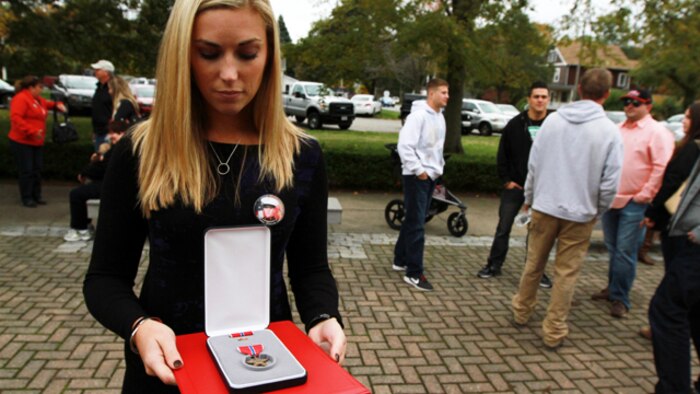 Erin Vasselian holds a Bronze Star Medal following a ceremony where her husband, Sgt. Daniel Vasselian, was posthumously awarded the Bronze Star Medal with Combat Distinguishing Device, Oct. 13, in front of the American Legion’s Lewis V. Dorsey Post 112 War Memorial in Abington, Mass. Daniel was posthumously awarded the Bronze Star Medal with Combat Distinguishing Device for combat actions while on his third deployment to Afghanistan. Erin Vasselian, and parents, Karen and Mark Vasselian, each were presented with medals during the ceremony. Daniel was killed in action Dec. 23, 2013 in Helmand Province, Afghanistan. (Photo by Sgt. Richard Blumenstein)