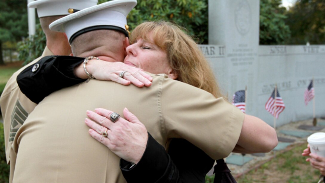 Karen Vasselian embraces Maj. James Nolan, Inspector-Instructor for Headquarters and Service Company and Weapons Company, , 1st Battalion, 25th Marine Regiment, following a ceremony where her son, Sgt. Daniel Vasselian, was posthumously awarded the Bronze Star Medal with Combat Distinguishing Device, Oct. 13, in front of the American Legion’s Lewis V. Dorsey Post 112 War Memorial in Abington, Mass. Daniel was posthumously awarded the Bronze Star Medal with Combat Distinguishing Device for combat actions while on his third deployment to Afghanistan. Daniel’s wife, Erin Vasselian, and parents, Karen and Mark Vasselian, each were presented with medals during the ceremony. Daniel was killed in action Dec. 23, 2013 in Helmand Province, Afghanistan. (Photo by Sgt. Richard Blumenstein)
