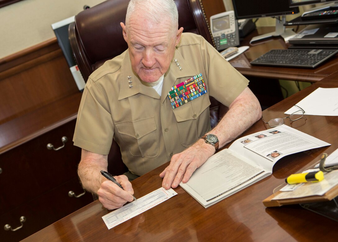 Lt. Gen. Richard P. Mills, commander of Marine Forces Reserve, donates money to the Combined Federal Campaign aboard Marine Corps Support Facility, New Orleans, Oct. 16, 2014. The CFC is the world’s largest and most successful annual workplace charity campaign, with almost 200 CFC campaigns throughout the country and overseas, raising millions of dollars each year. The new CFC website (www.cfctoday.org) will make donating easier and more efficient for those who choose to donate. 