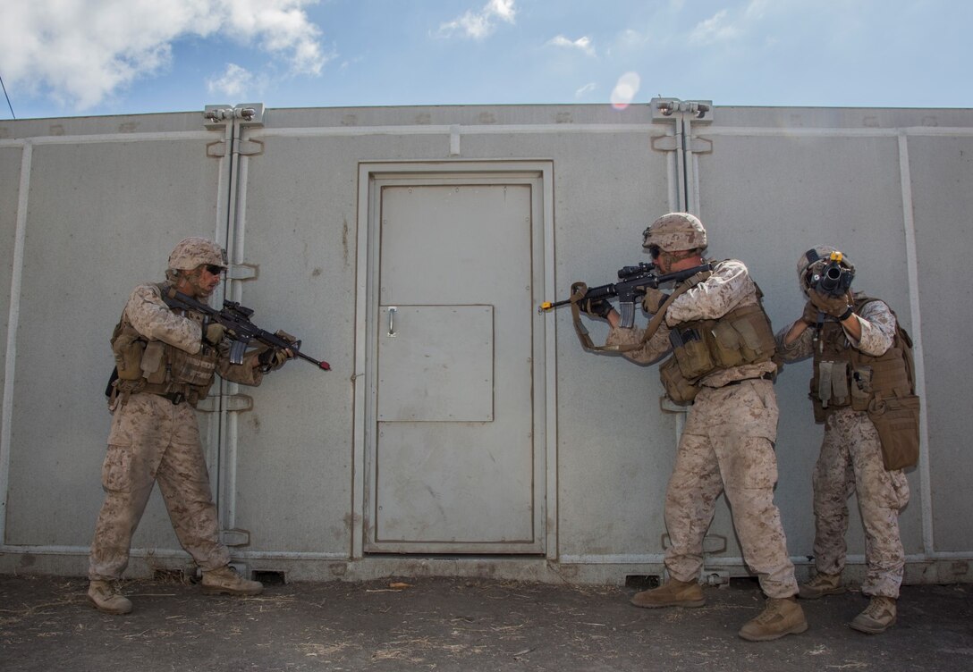 U.S. Marines with Battalion Landing Team, 3rd Battalion, 1st Marine Regiment, 15th Marine Expeditionary Unit, prepare to breach a door during a helicopter-raid exercise aboard Camp Pendleton, Calif., Oct. 16, 2014. BLT 3/1 is scheduled to deploy as the 15th MEU’s ground combat element next spring. (U.S. Marine Corps photo by Sgt. Emmanuel Ramos/Released)