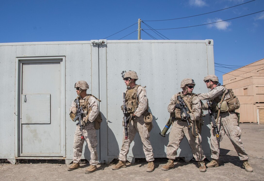 U.S. Marines with Battalion Landing Team, 3rd Battalion, 1st Marine Regiment, 15th Marine Expeditionary Unit, prepare to breach a door during a helicopter-raid exercise aboard Camp Pendleton, Calif., Oct. 16, 2014. BLT 3/1 is scheduled to deploy as the 15th MEU’s ground combat element next spring. (U.S. Marine Corps photo by Sgt. Emmanuel Ramos/Released)