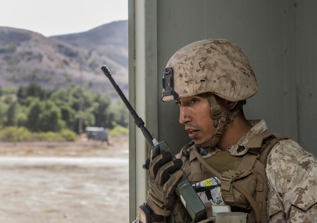 U.S. Marine Sgt. Paul Luna radios for an extraction during a helicopter-raid exercise aboard Camp Pendleton, Calif., Oct. 16, 2014. Luna is a squad leader with Kilo Company, Battalion Landing Team, 3rd Battalion, 1st Marine Regiment, 15th Marine Expeditionary Unit. BLT 3/1 is scheduled to deploy as the 15th MEU’s ground combat element next spring. (U.S. Marine Corps photo by Sgt. Emmanuel Ramos/Released)