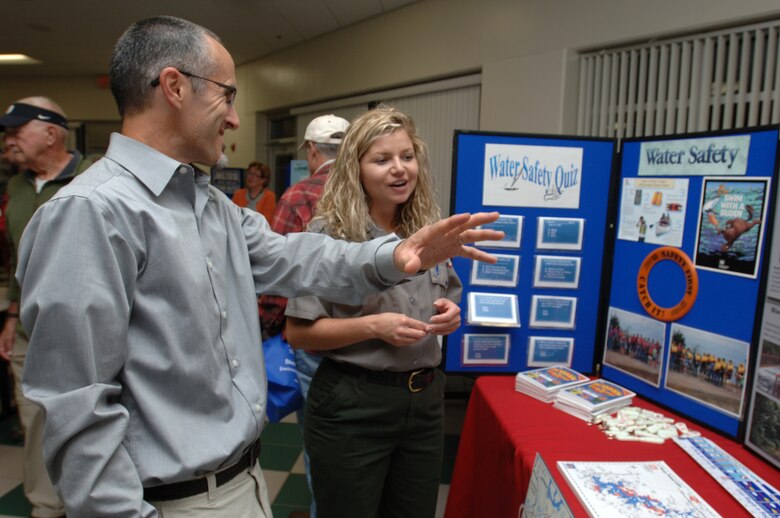 J. Percy Priest Lake Park Ranger Amber Jones talks with Frank Bailey, a biology professor at Middle Tennessee State University, during a Stones River watershed workshop Oct. 20, 2014 at the Patterson Park Community Center in Murfreesboro, Tenn. The event was hosted by the Tennessee Department of Environment and Conservation.