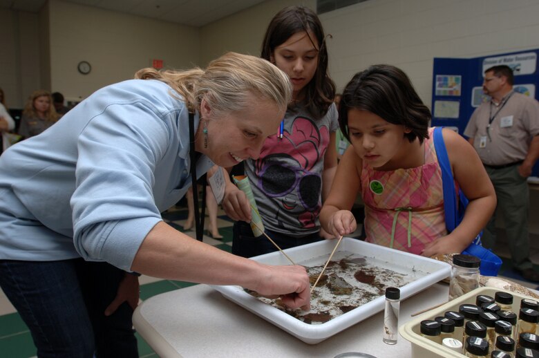 Kim Laster, stream biologist with the TDEC Division of Water Resources, shows several kids samples of aquatic life taken from the Stones River during a Stones River watershed workshop Oct. 20, 2014 at Patterson Park Community Center in Murfreesboro, Tenn. She taught them the relationship between the presence and absence of certain macro invertebrate and how it indicates the level of water quality in a watershed.