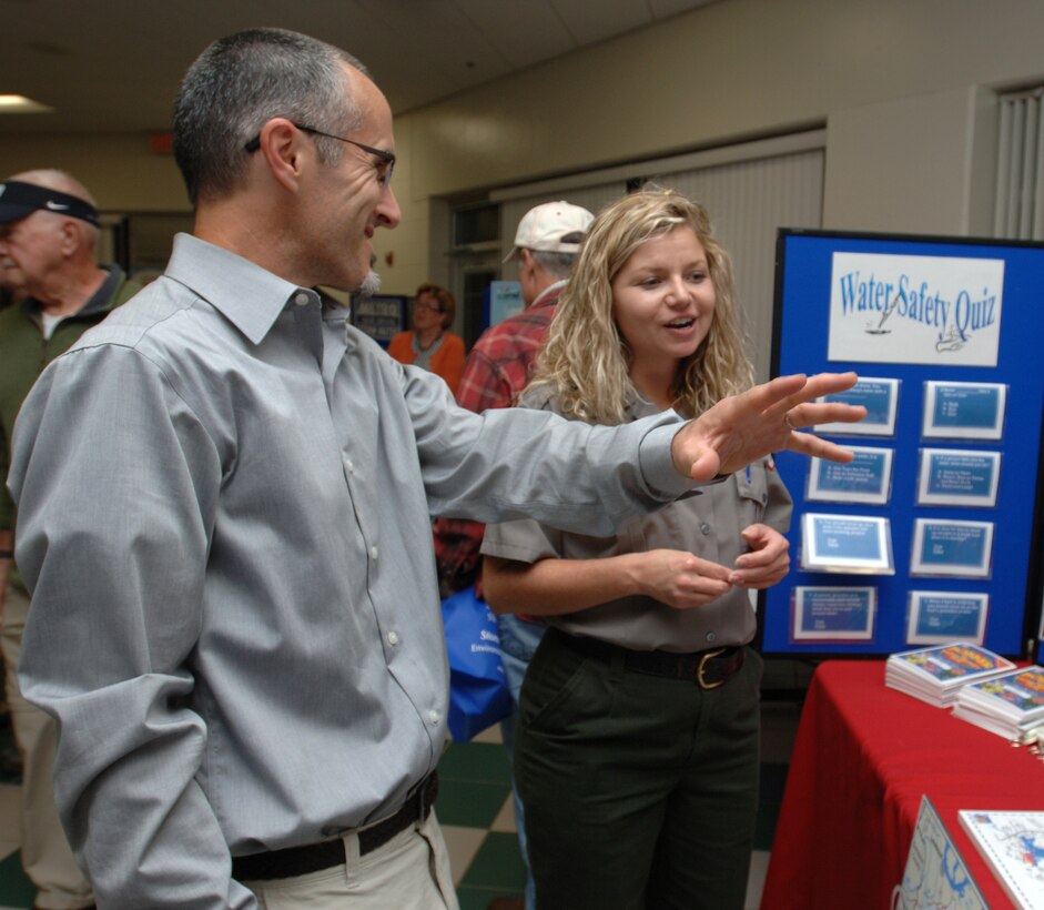 J. Percy Priest Lake Park Ranger Amber Jones talks with Frank Bailey, a biology professor at Middle Tennessee State University, during a Stones River watershed workshop Oct. 20, 2014 at the Patterson Park Community Center in Murfreesboro, Tenn. The event was hosted by the Tennessee Department of Environment and Conservation.
