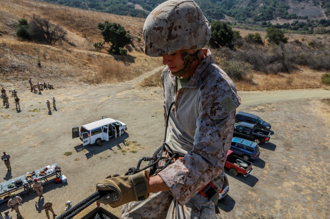 U.S. Marine Cpl. Brian Mullins rappels from a tower during a helicopter rope-suspension techniques masters course aboard Camp Pendleton, Calif., Oct. 14, 2014. Mullins is a parachute rigger with Battalion Landing Team, 3rd Battalion, 1st Marines, 15th Marine Expeditionary Unit.  BLT 3/1 is deploying this spring as the 15th MEU’s ground combat element. (U.S. Marine Corps photo by Cpl. Steve H. Lopez/Released)