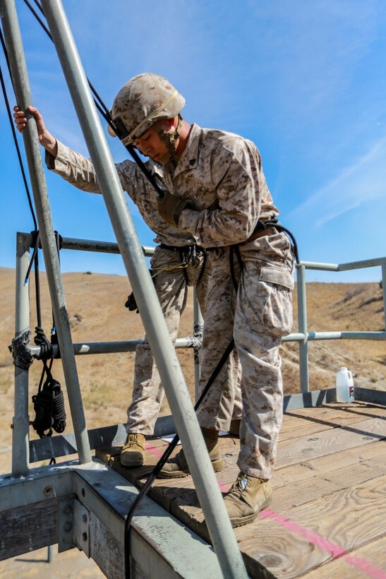 U.S. Marine Sgt. Andrew Shelly prepares to rappel from a tower during a helicopter rope-suspension techniques masters course aboard Camp Pendleton, Calif., Oct. 14, 2014. Shelly is a machine gunner with Battalion Landing Team, 3rd Battalion, 1st Marines, 15th Marine Expeditionary Unit. BLT 3/1 is deploying this spring as the 15th MEU’s ground combat element.  (U.S. Marine Corps photo by Cpl. Steve H. Lopez/Released)