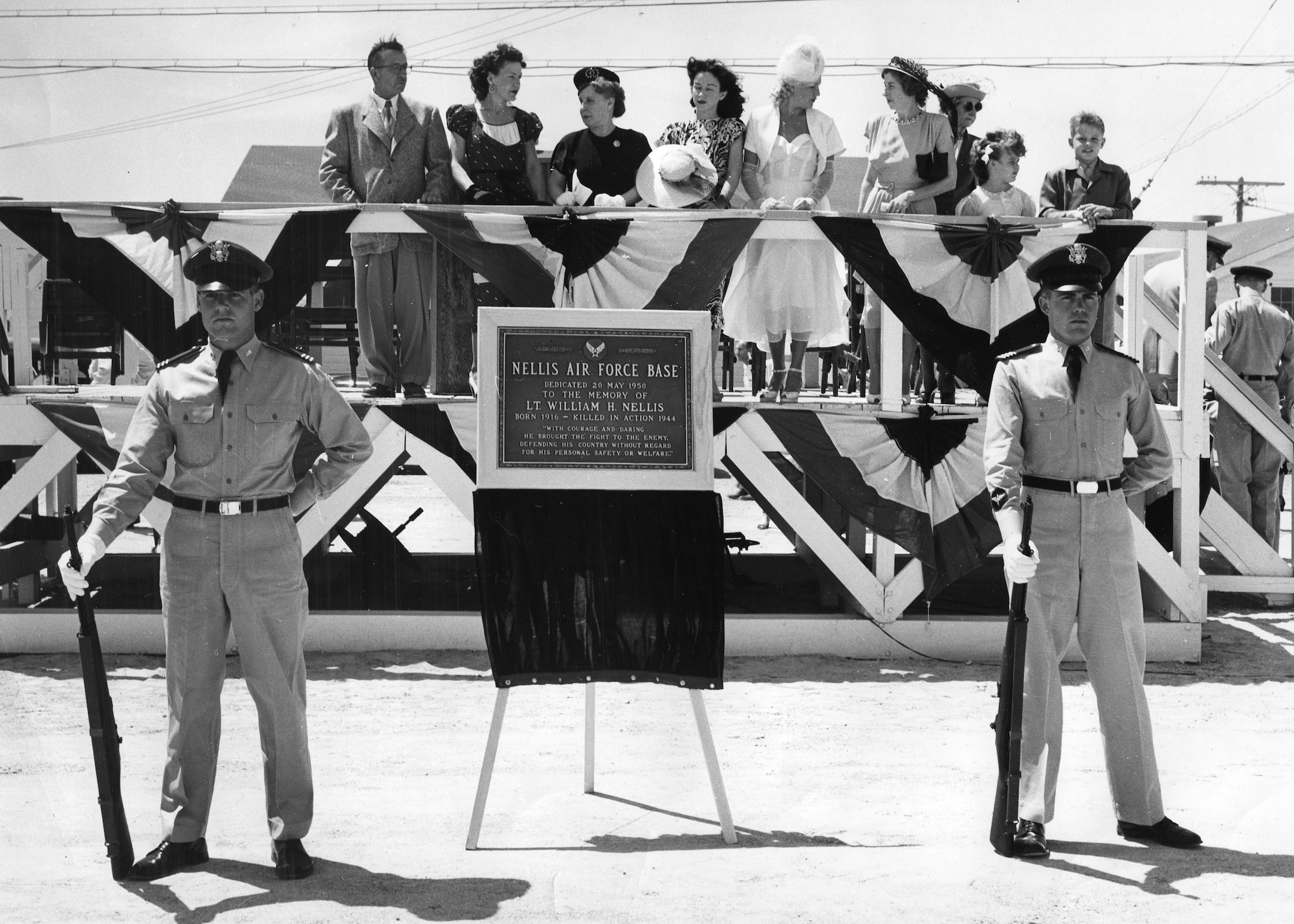 Gary Nellis (far right on the platform), son of the late 1st Lt. William Harrell Nellis, Nellis Air Force Base’s namesake, attends the base’s dedication ceremony at Nellis AFB, Nev., May 20, 1950. The plaque on display is now at the foot of the base flagpole in front of the U.S. Air Force Warfare Center.  William Nellis’ P-47 Thunderbolt was shot down in World War II during the Battle of the Bulge. (U.S. Air Force photo courtesy of the 99th Air Base Wing Historian Office)
