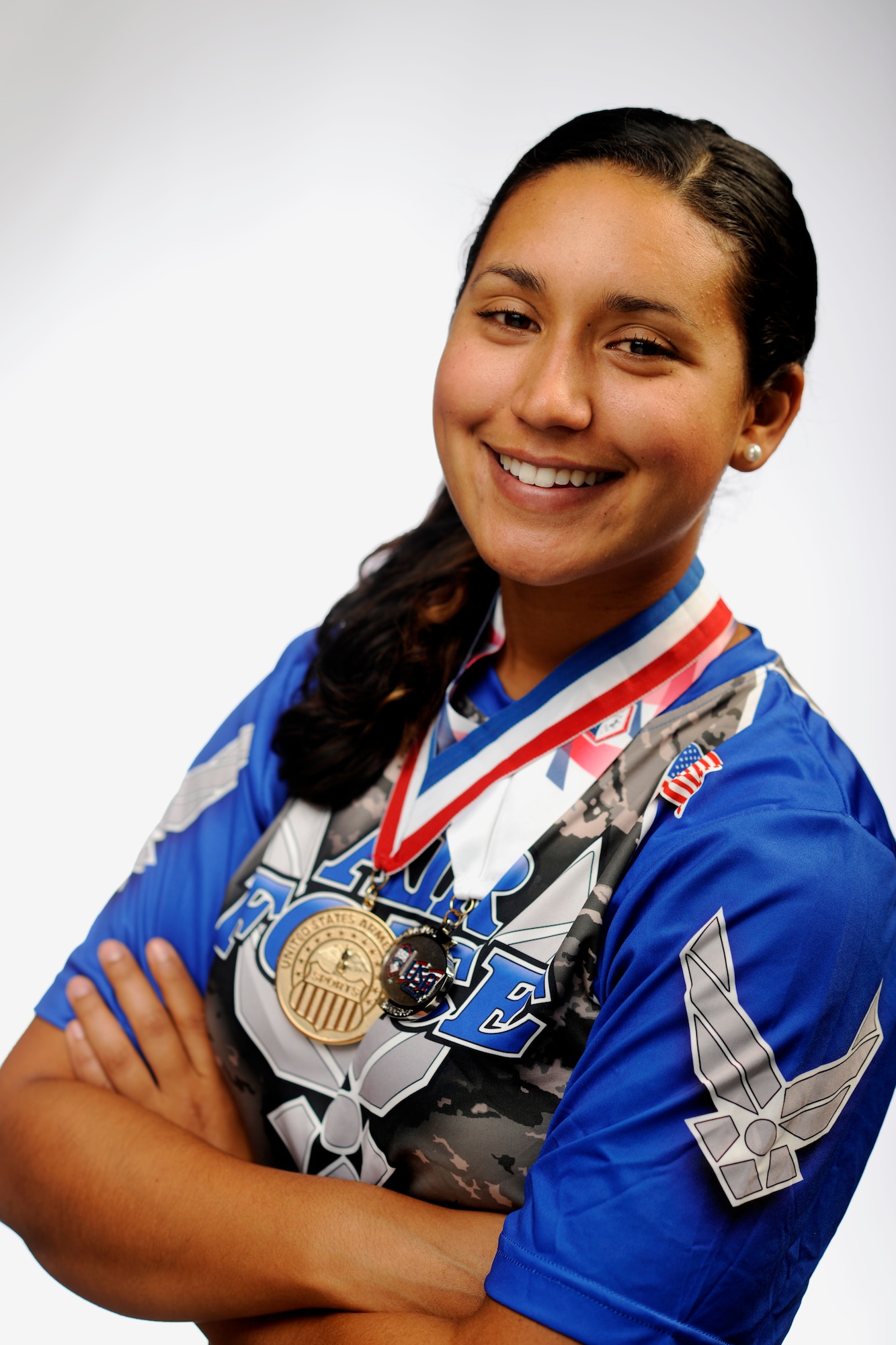 Senior Airman Nesha Humes poses with the gold and sliver medals at Joint Base Andrews, Md., Oct. 17, 2014. Airman Humes represented the U.S. Air Force as a member of the All-Air Force Women’s and All-Armed Forces Women’s Softball Teams Sept. 14 to 29, 2014. (U.S. Air Force photo/ Staff Sgt. Nichelle Anderson)
