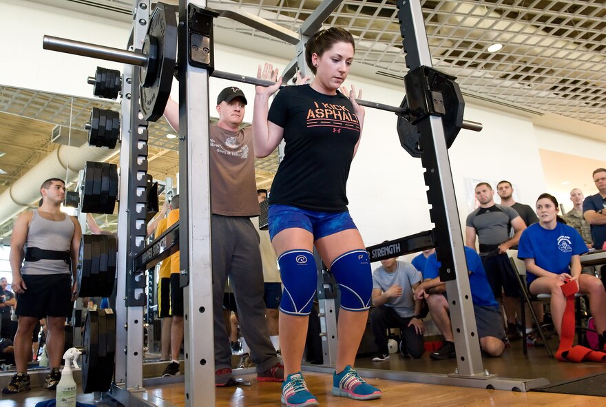 Sarah McGinness steadies 145 pounds on her shoulders prior to her first attempt at the squat during the 2014 Dover Air Force Base Powerlifting Competition Oct. 17, 2014, at the Fitness Center on Dover AFB, Del. McGinness took first place in the 148-pound weight class for females with a combined total of 435 pounds in the squat, bench press and deadlift. (U.S. Air Force photo/Roland Balik)