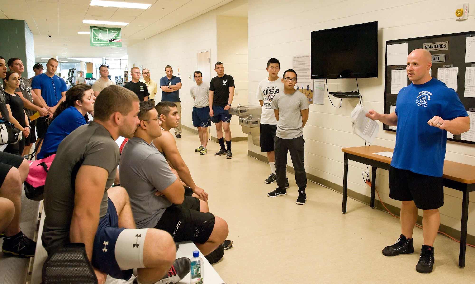 Zachary Replogle briefs military and civilian competitors entered in the 2014 Dover Air Force Base Powerlifting Competition on the proper bench press form Oct. 17, 2014, at the Fitness Center on Dover AFB, Del. The competition was sponsored by the Logistics Officer Association and used Revolution Powerlifting Syndicate rules to judge competitors on their squat, bench press and deadlift attempts. (U.S. Air Force photo/Roland Balik)