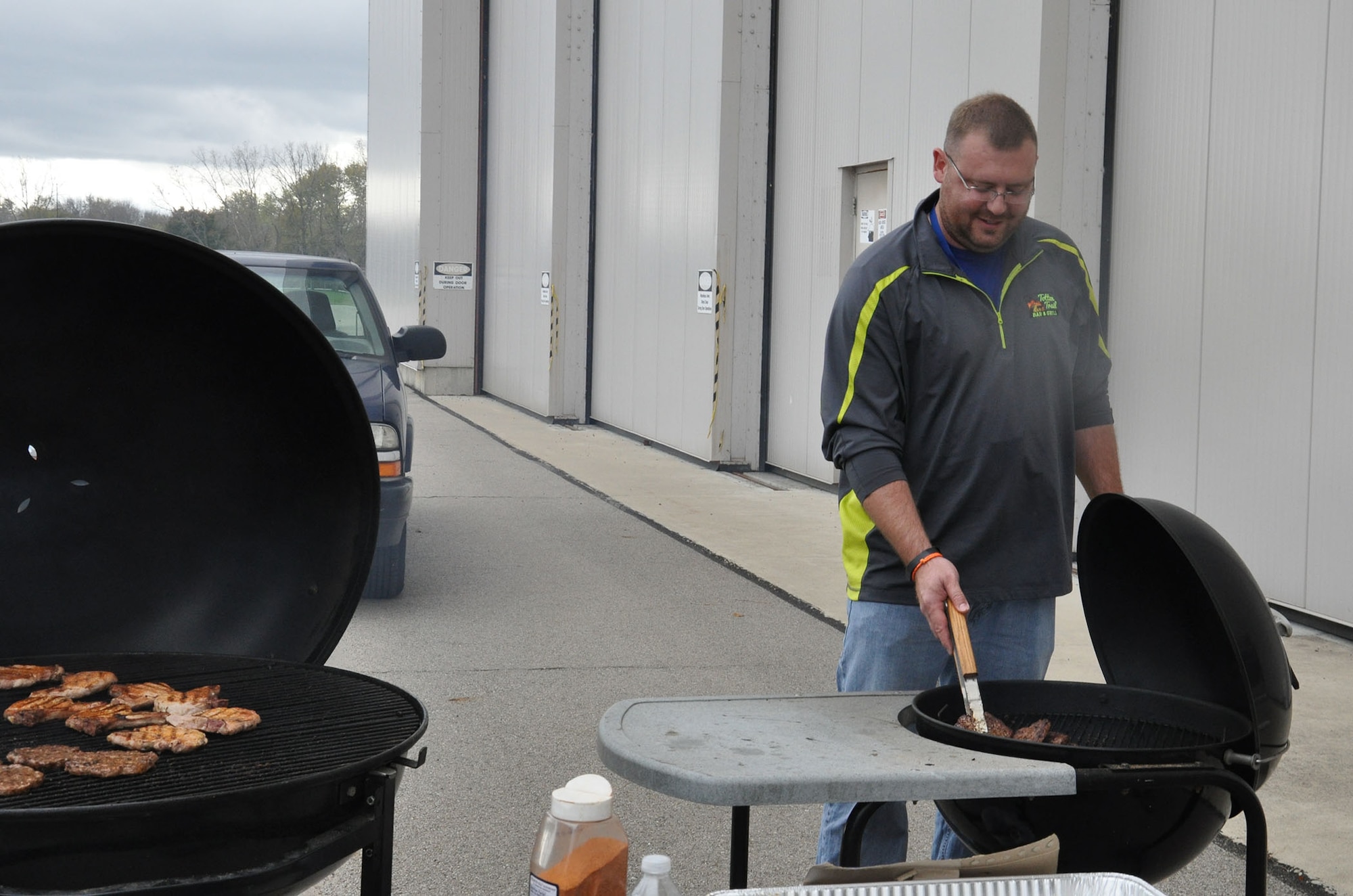 WRIGHT-PATTERSON AIR FORCE BASE, Ohio – Master Sgt. Shad Lavender, 445th Maintenance Group plans and programs, mans the grill during the 445th Maintenance Group burger burn Oct. 21, 2014. The burger burn was held to help celebrate the maintainers closing out FY14 with an above average mission capable rate for the wing's fleet of nine C-17 Globemaster IIIs. (U.S. Air Force photo/Stacy Vaughn)