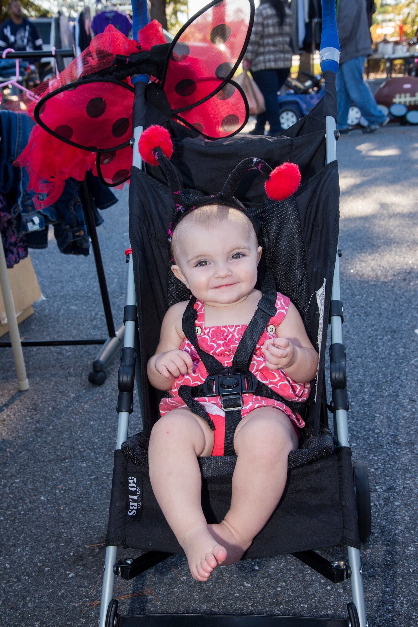 Acadia, daughter of U.S. Air Force Master Sgt. Sean Hoke, 723 Aircraft Maintenance Squadron, tries on a ladybug costume at a yard sale held Oct. 18, 2014 at Moody Air Force Base, Ga. The 23d Force Support Squadron hosts the biannual yard sale every fall and spring.(U.S. Air Force photo by Senior Airman Sandra Marrero/Released)
