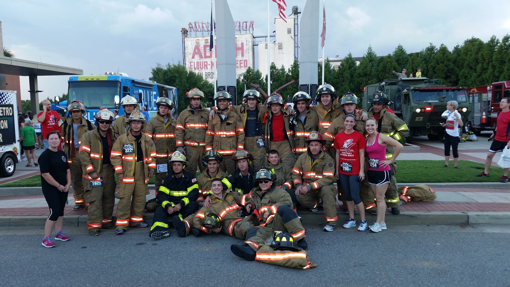 Airmen from the 20th Civil Engineer Squadron fire department and their family members gather for a group photo before the Tunnel to Towers 5K run/walk in Columbia, S.C., Sept. 19, 2014. The team ran together representing the Shaw firefighters during a three mile run, wearing their protective gear. (Courtesy photo/Released)
