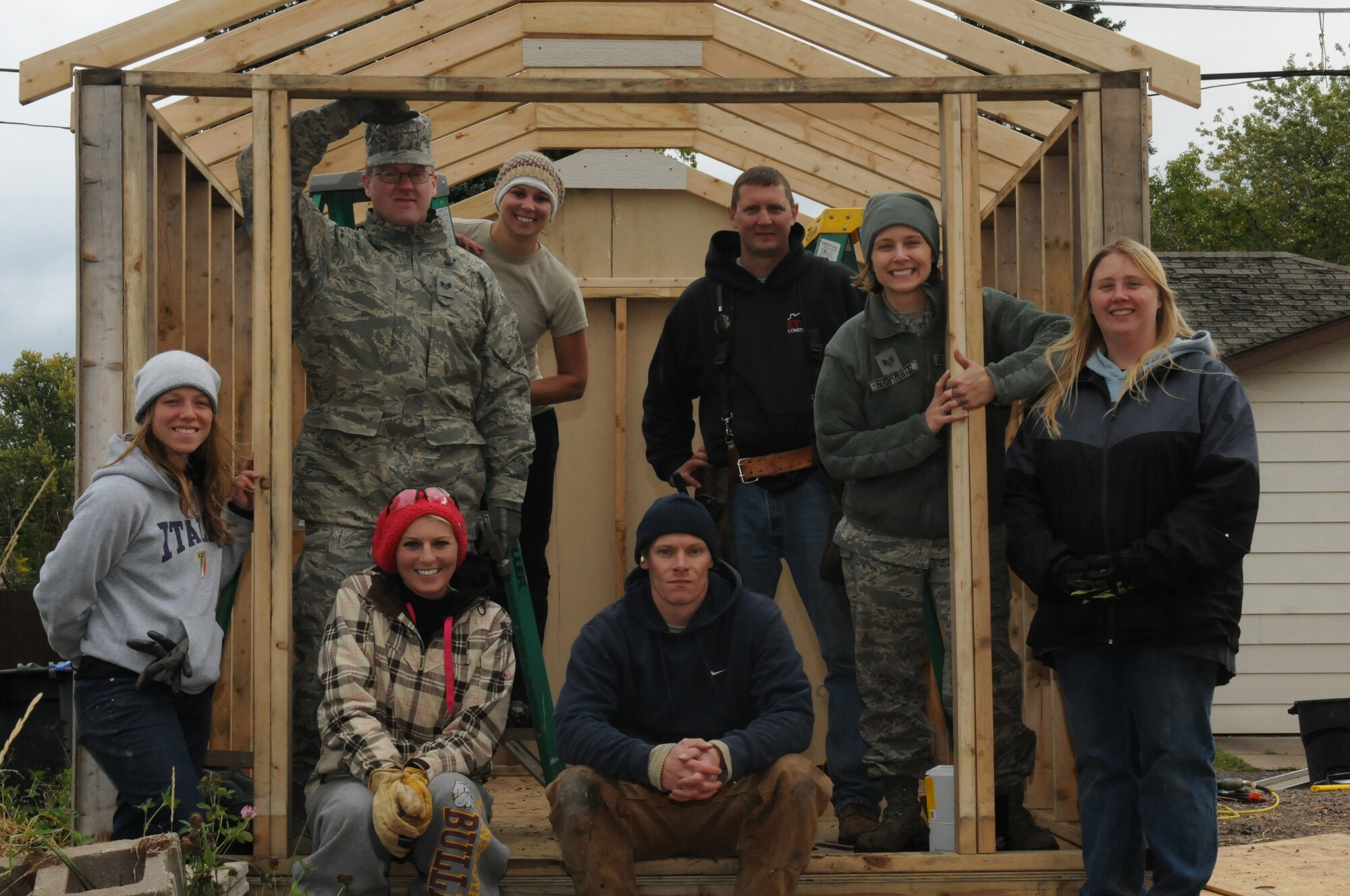 Airmen with the 148th Fighter Wing and Habitat for Humanity volunteers showcase the construction progress of a shed Oct. 4, 2014.  Duluth, Minn. based members of the Minnesota Air National Guard volunteered for their third straight year, working with Habitat for Humanity on community construction projects.  (U.S. Air National Guard photo by Tech. Sgt. Amie M. Muller)