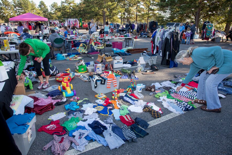 Shoppers look at items at a yard sale held by the 23d Force Support Squadron Oct. 18, 2014 at Moody Air Force Base, Ga. Base yard sales allow military personnel and the public to buy and sell goods at an affordable price. (U.S. Air Force photo by Senior Airman Sandra Marrero/Released)
