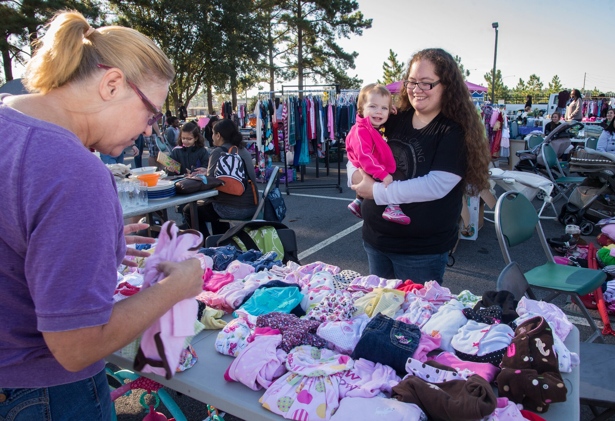 Diane Stanfield, community member, shops for infant clothing at a yard sale held Oct. 18, 2014 at Moody Air Force Base, Ga. More than 25 sellers participated in the event. (U.S. Air Force photo by Senior Airman Sandra Marrero/Released)
