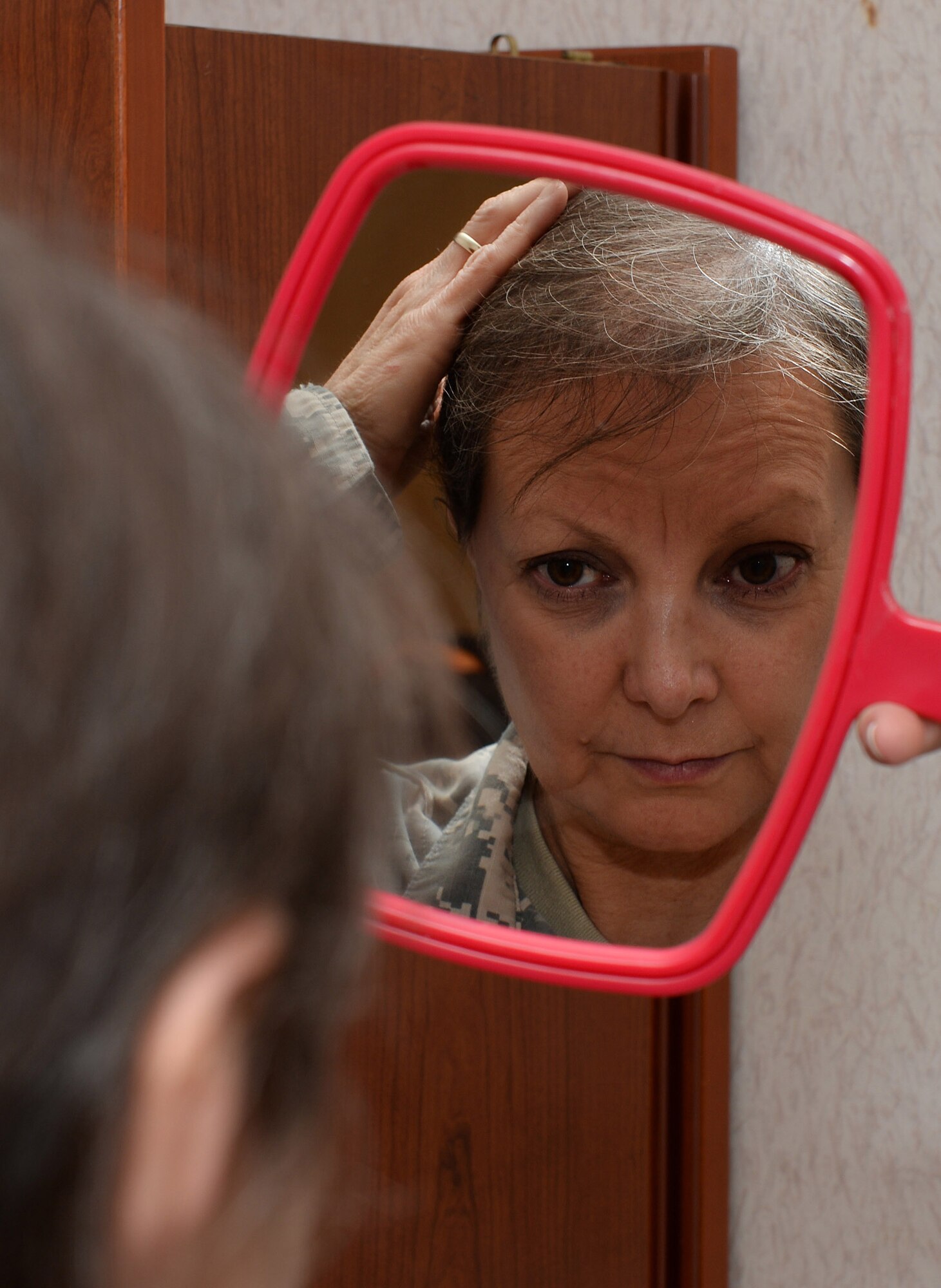 U.S. Army Maj. Mari Groebner, McDonald Army Health Center Peri-Operative Services chief, was diagnosed with breast cancer in 2012. Since completing chemotherapy and medication treatment, Groebner spends time offering words of encouragement to others who battle with similar circumstances. (U.S. Air Force photo by Staff Sgt. Teresa J. Cleveland/Released)