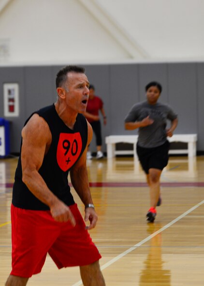 John Walters, 436th Force Support Squadron fitness program manager, motivates Airmen during a “90+” workout Oct. 15, 2014, at the Fitness Center on Dover Air Force Base, Del. Walters, who created the old “90n90” program, now coaches more than 100 Airmen through his new “90+” program. (U.S. Air Force photo/Airmen 1st Class William Johnson)