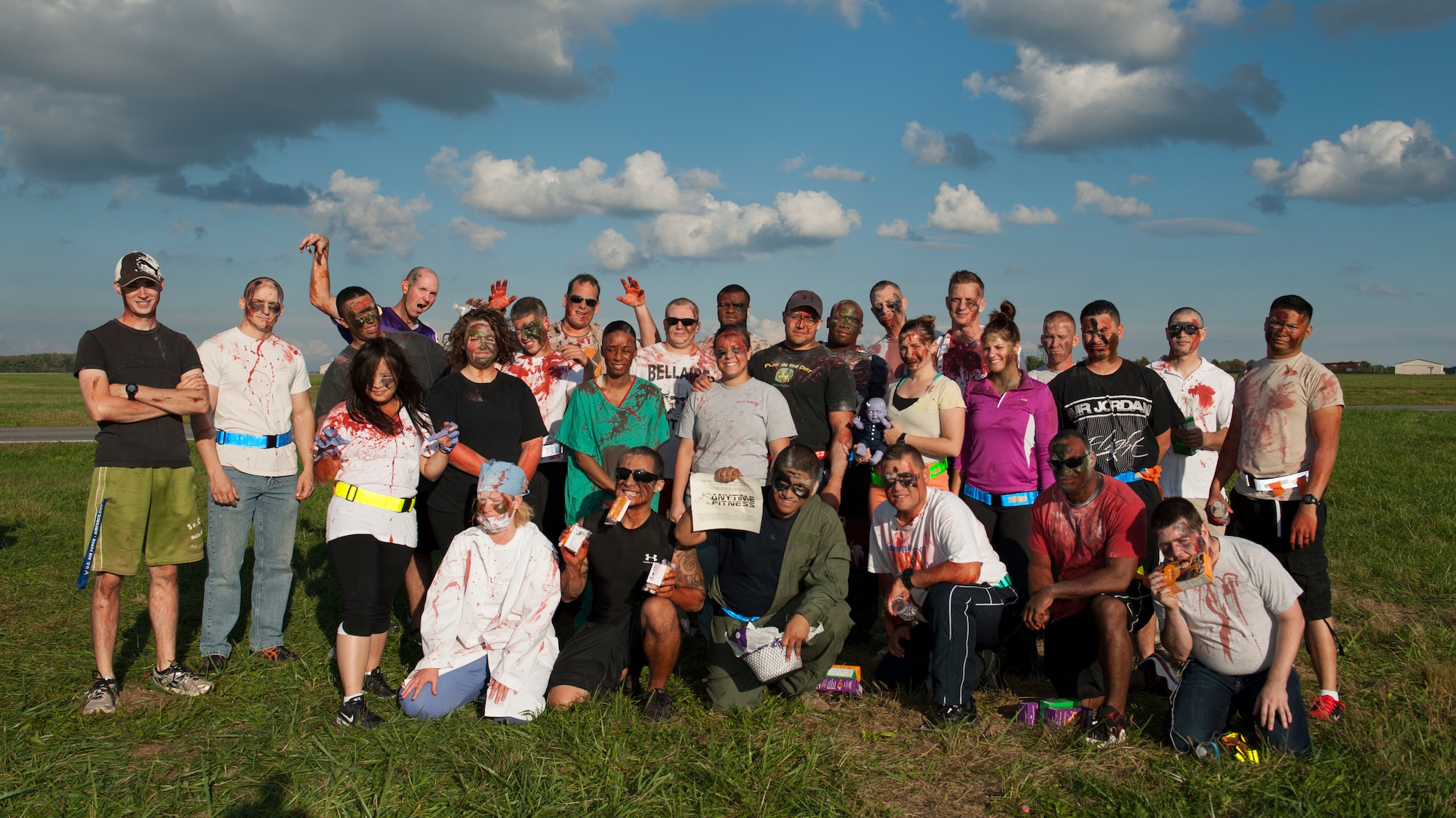 Team Dover Airmen dressed as zombies pose for a group photo after the conclusion of the Zombies of Dover race Oct. 16, 2014, at Dover Air Force Base, Del. This was the second annual Zombies of Dover race. (U.S. Air Force photo/Airman 1st Class Zachary Cacicia)