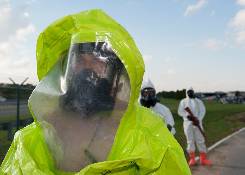 Airman 1st Class Artemiy Shlyaptsev, 436th Civil Engineer Squadron emergency management apprentice, stands ready to ‘inspect’ runners at the finish line of the Zombies of Dover race Oct. 16, 2014, at Dover Air Force Base, Del.  The 436th CES Emergency Management Flight inspected runners for ‘contamination’ as they crossed the finish line. (U.S. Air Force photo/Airman 1st Class Zachary Cacicia)