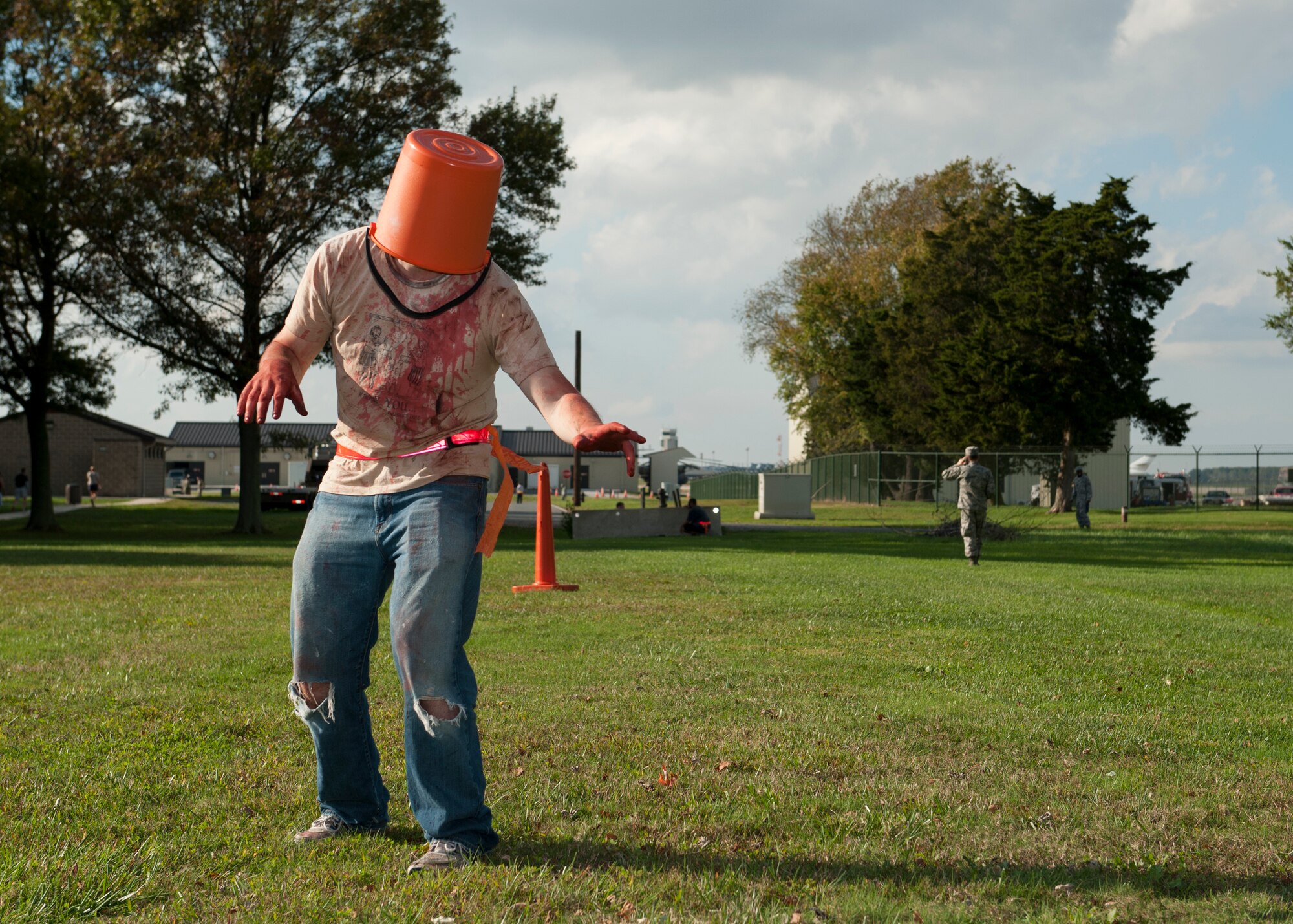 Senior Airman Timothy Zajeski, 436th Communications Squadron transmission systems technician, stumbles through the Zombies of Dover race route Oct. 16, 2014, at Dover Air Force Base, Del. The five kilometer race course was run on Perimeter Road, past the Family Camp and Eagle Nest Park. (U.S. Air Force photo/Airman 1st Class Zachary Cacicia)