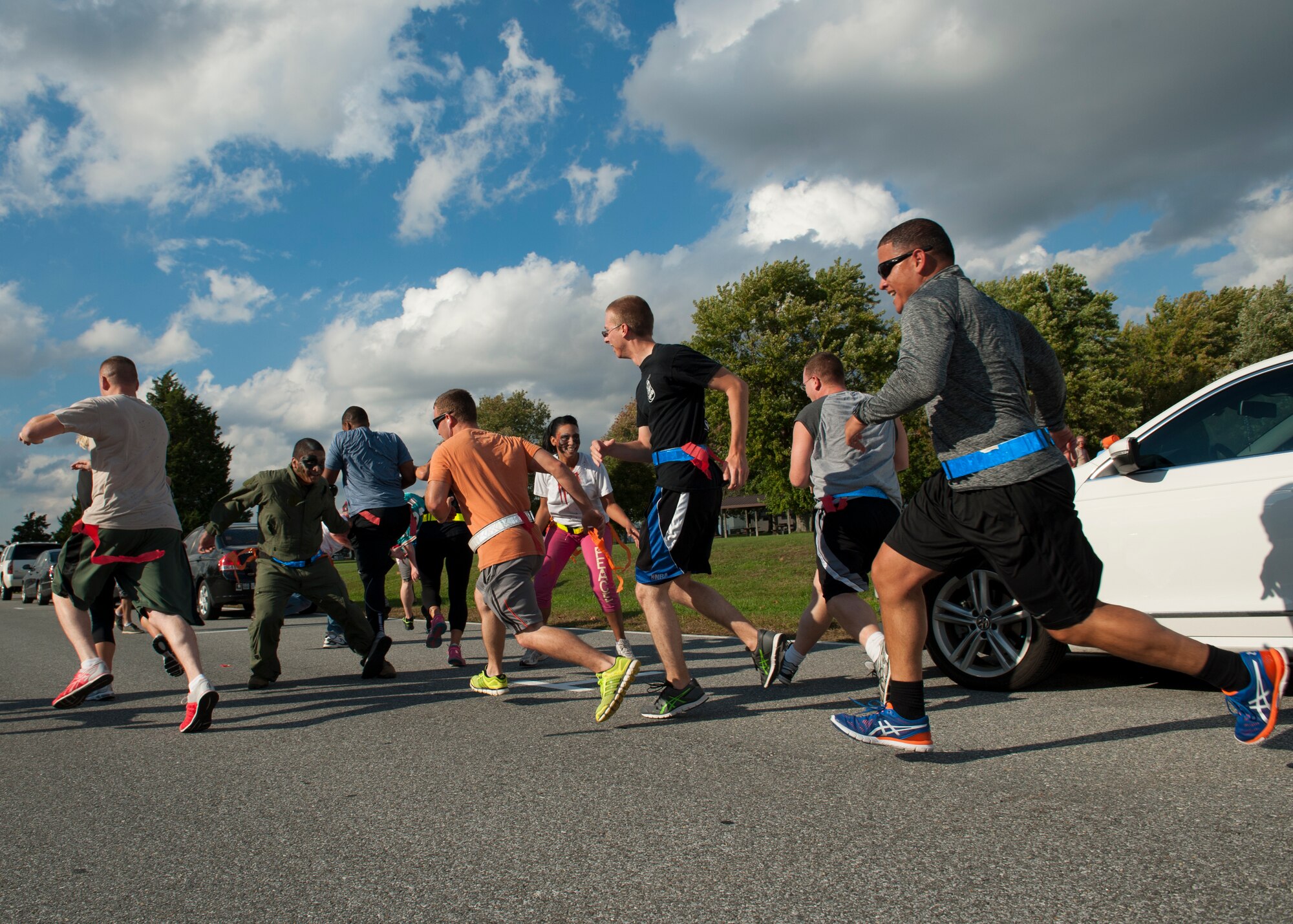 Runners attempt to avoid zombies during the Zombies of Dover race Oct. 16, 2014, at Dover Air Force Base, Del. Runners had to duck and dodge zombies in an attempt to stay ‘alive’ throughout the race. (U.S. Air Force photo/Airman 1st Class Zachary Cacicia)