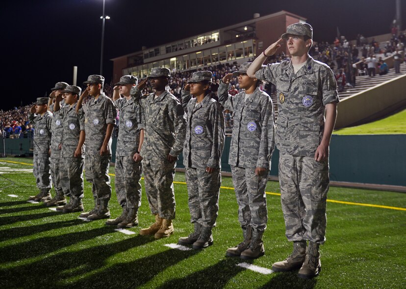 Members of the Abilene High School (AHS) Air Force JROTC render a salute during the AHS football game Oct. 17, 2014, in Abilene, Texas. The AHS Eagles defeated the Odessa Permian Panthers 30-13. (U.S. Air Force photo by Airman 1st Class Kedesha Pennant/Released)