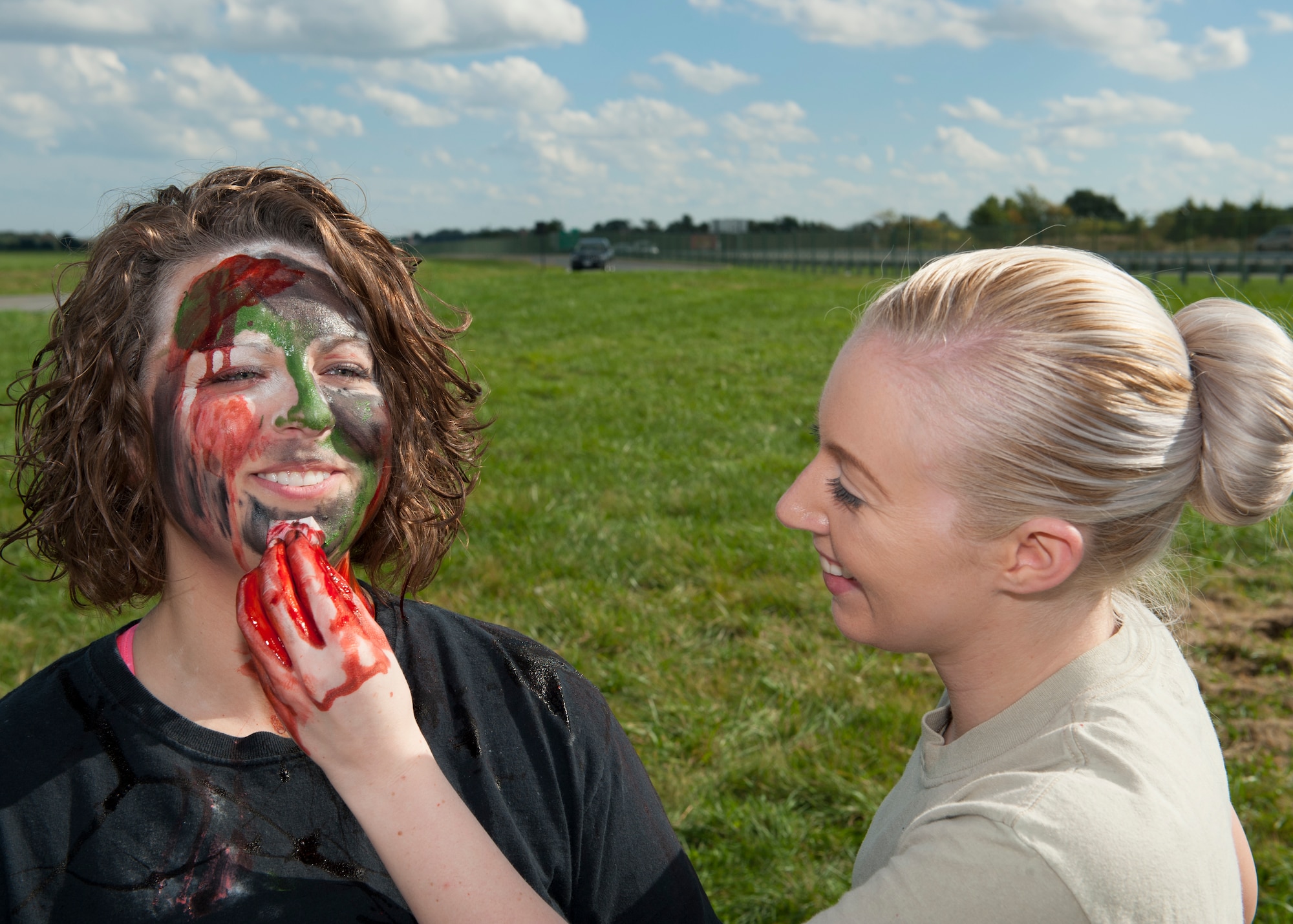 Staff Sgt. Ashton Collins, 436th Dental Squadron dental assistant, applies zombie makeup to the face of Staff Sgt. Katie Maas, 436th DS dental technician, prior to the start of the Zombies of Dover race Oct. 16, 2014, at Dover Air Force Base, Del. Prior to the race, the zombies received theirmakeup. (U.S. Air Force photo/Airman 1st Class Zachary Cacicia)