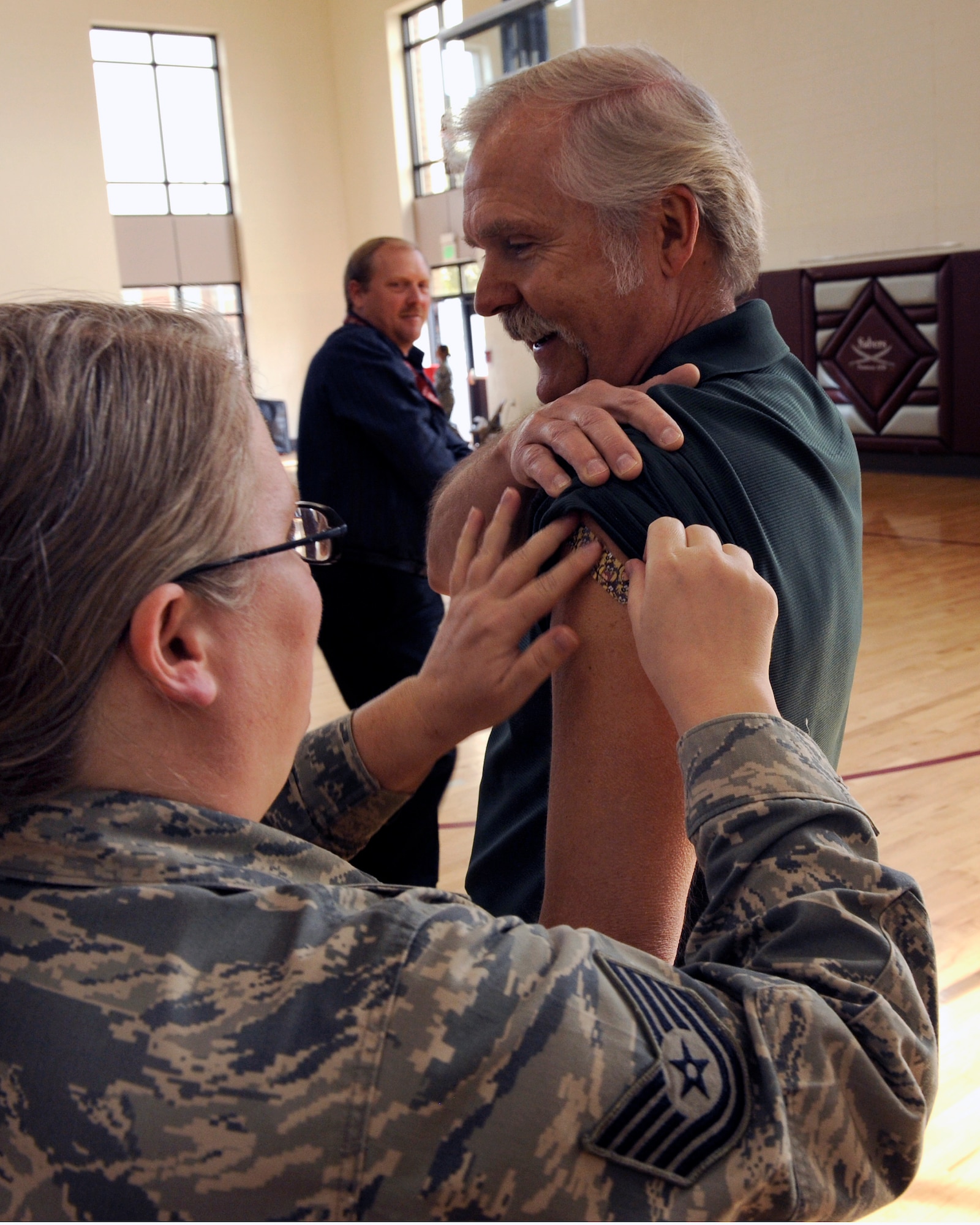 PETERSON AIR FORCE BASE, Colo. – Mick Crews, Air Force Space Command space control operator, gets a bandage put over the area where he received his influenza vaccine at the RP Lee Youth Center Oct. 16. The 21st Medical Group set up a flu line to accommodate all Team Pete employees and families needing their annual flu shot. Airmen and their families can get either the mist or the shot at the immunization clinic to help protect them against getting sick this flu season. (U.S. Air Force photo/Airman 1st Class Rose Gudex)