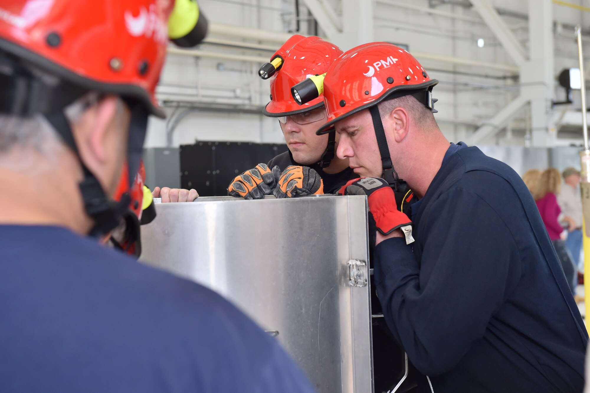 910th Airlift Wing Civil Engineer firefighters inspect a modular metal cylinder used in grain bin rescues. As the first product of the Air Force Community Partnership Program at YARS, the Ohio Bureau of Worker’s Compensation worked with the Ohio State Fire Academy to bring their innovative grain bin rescue training platform to YARS, allowing first responders to gain potentially life-saving skills. Approximately 50 firefighters from several local fire departments, including 14 from the 910th Civil Engineer Fire Department here, participated. U.S. Air Force photo/Eric M. White