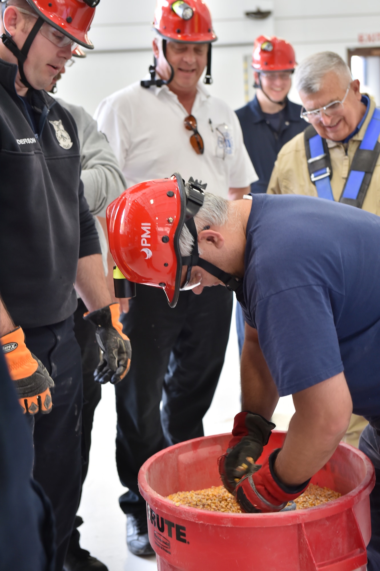 A 910th Airlift Wing Civil Engineer firefighter pulls a rope attached to a wooden disk buried in a bin of grain Oct. 17, here. The training apparatus is designed to demonstrate the tremendous pressure on a victim trapped in a grain storage unit, adding complexity and risk to rescue operations. As the first product of the Air Force Community Partnership Program at YARS, the Ohio Bureau of Worker’s Compensation worked with the Ohio State Fire Academy to bring their innovative grain bin rescue training platform to YARS, allowing first responders to gain potentially life-saving skills. Approximately 50 firefighters from several local fire departments, including 14 from the 910th Civil Engineer Fire Department here, participated. U.S. Air Force photo/Eric M. White