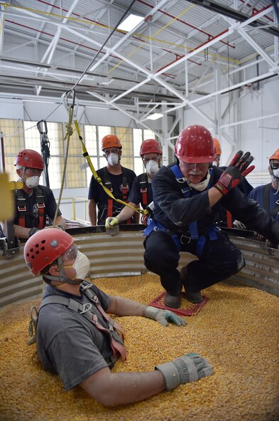 Ohio Fire Academy instructor Dave Torsell instructs firefighters from local fire departments on the risks of rescuing someone trapped in a grain storage bin as Damascus Fire Department firefighter Zack Coker portrays a victim. As the first product of the Air Force Community Partnership Program at YARS, the Ohio Bureau of Worker’s Compensation worked with the Ohio Fire Academy to bring their innovative grain bin rescue training platform to YARS, allowing first responders to gain potentially life-saving skills. Approximately 50 firefighters from several local fire departments, including 14 from the 910th Civil Engineer Fire Department here, participated. U.S. Air Force photo/Eric M. White