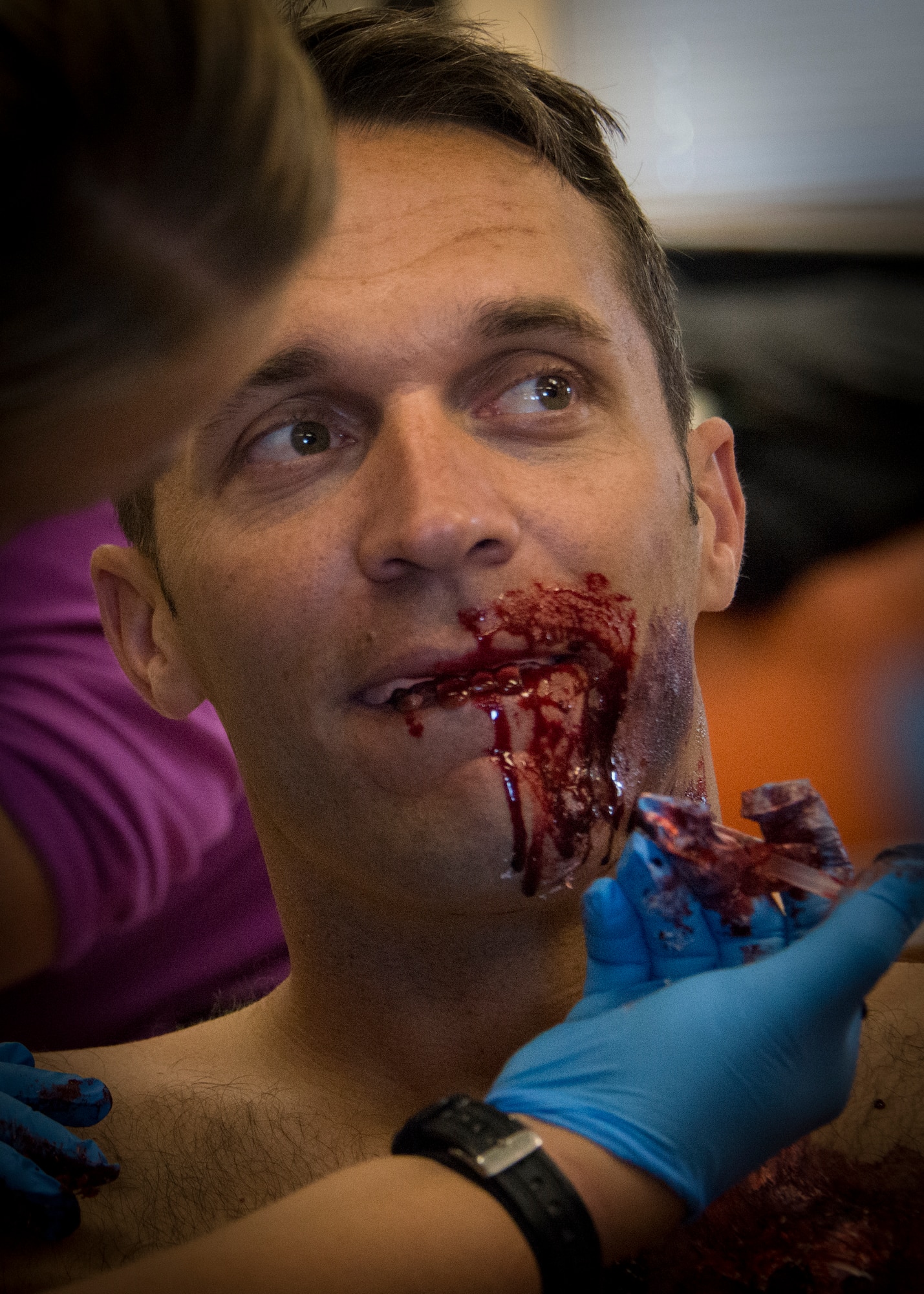 A 96th Medical Group moulage team member applies fake blood and teeth to a simulated victim prior to the annual major accident response exercise at the 6th Ranger Training Battalion Oct. 16 at Eglin Air Force Base, Fla.  The moulage team created simulated injuries to approximately 10 Soldiers to add realism to a boat and helicopter crash scenario.  (U.S. Air Force photo/Tech. Sgt. Jasmin Taylor)