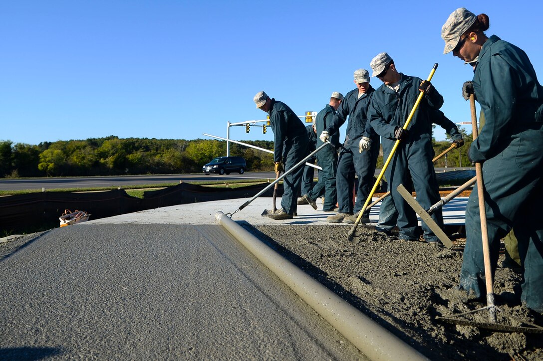 U.S. Air Force Airmen from the 633rd Civil Engineer Squadron smooth out concrete for the new F-15 Eagle static display at Langley Air Force Base, Va., Oct. 17, 2014. The F-15 Eagle on display commemorates Langley’s past, as the aircraft was flown here since 1976 before the F-22 Raptor took its place in 2010. (U.S. Air Force photo by Senior Airman Austin Harvill/Released)
