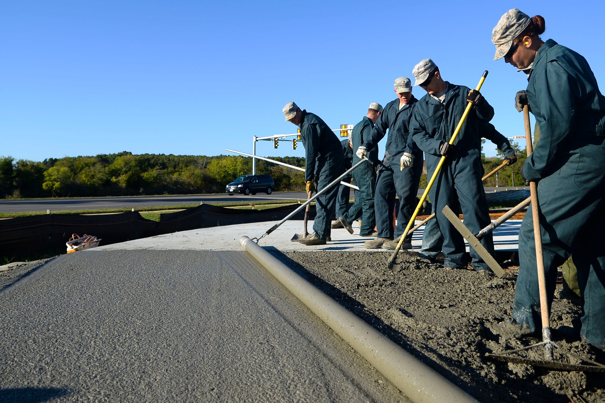U.S. Air Force Airmen from the 633rd Civil Engineer Squadron smooth out concrete for the new F-15 Eagle static display at Langley Air Force Base, Va., Oct. 17, 2014. The F-15 Eagle on display commemorates Langley’s past, as the aircraft was flown here since 1976 before the F-22 Raptor took its place in 2010. (U.S. Air Force photo by Senior Airman Austin Harvill/Released)