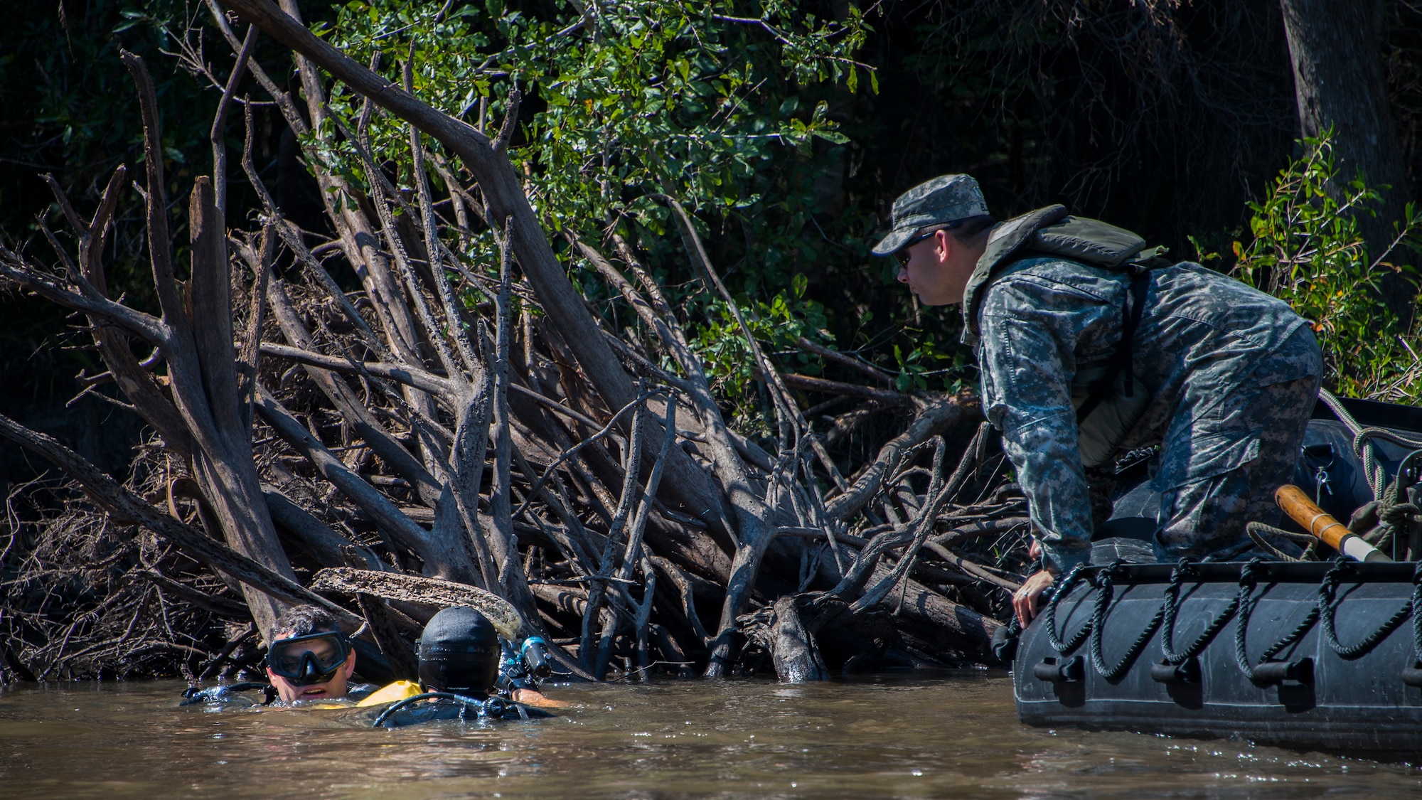 A Soldier moves in to help a Ranger dive team member looking for a simulated missing person during the 6th Ranger Training Battalion’s annual major accident response exercise Oct. 16 at Eglin Air Force Base, Fla.  Medics and first responders from the 6th RTB, 96th Test Wing and the local area responded to boating and down aircraft scenarios deep within the Eglin range.  (U.S. Air Force photo/Tech. Sgt. Jasmin Taylor)